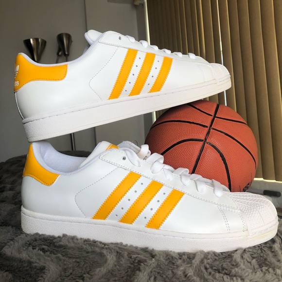 white and yellow adidas shoes